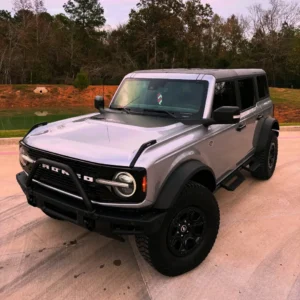 Silver Ford Bronco with custom vinyl wraps in Stagecoach TX parked outside