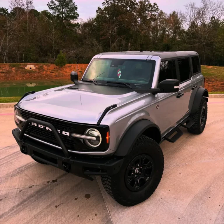 Silver Ford Bronco with custom vinyl wraps in Stagecoach TX parked outside